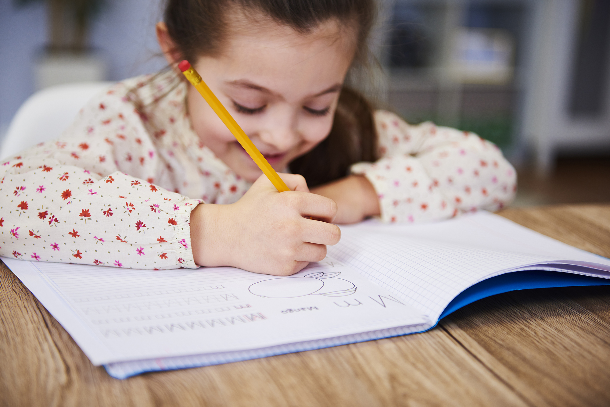 young girl working on her handwriting in a hand writing therapy session